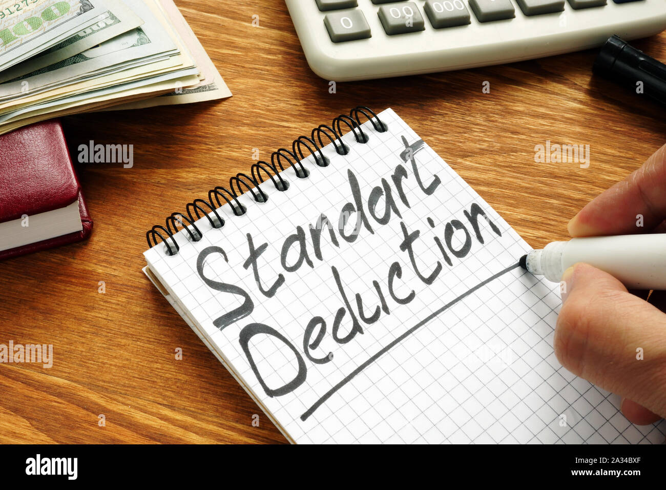 Businessman writes Standard Deduction by marker. Stock Photo