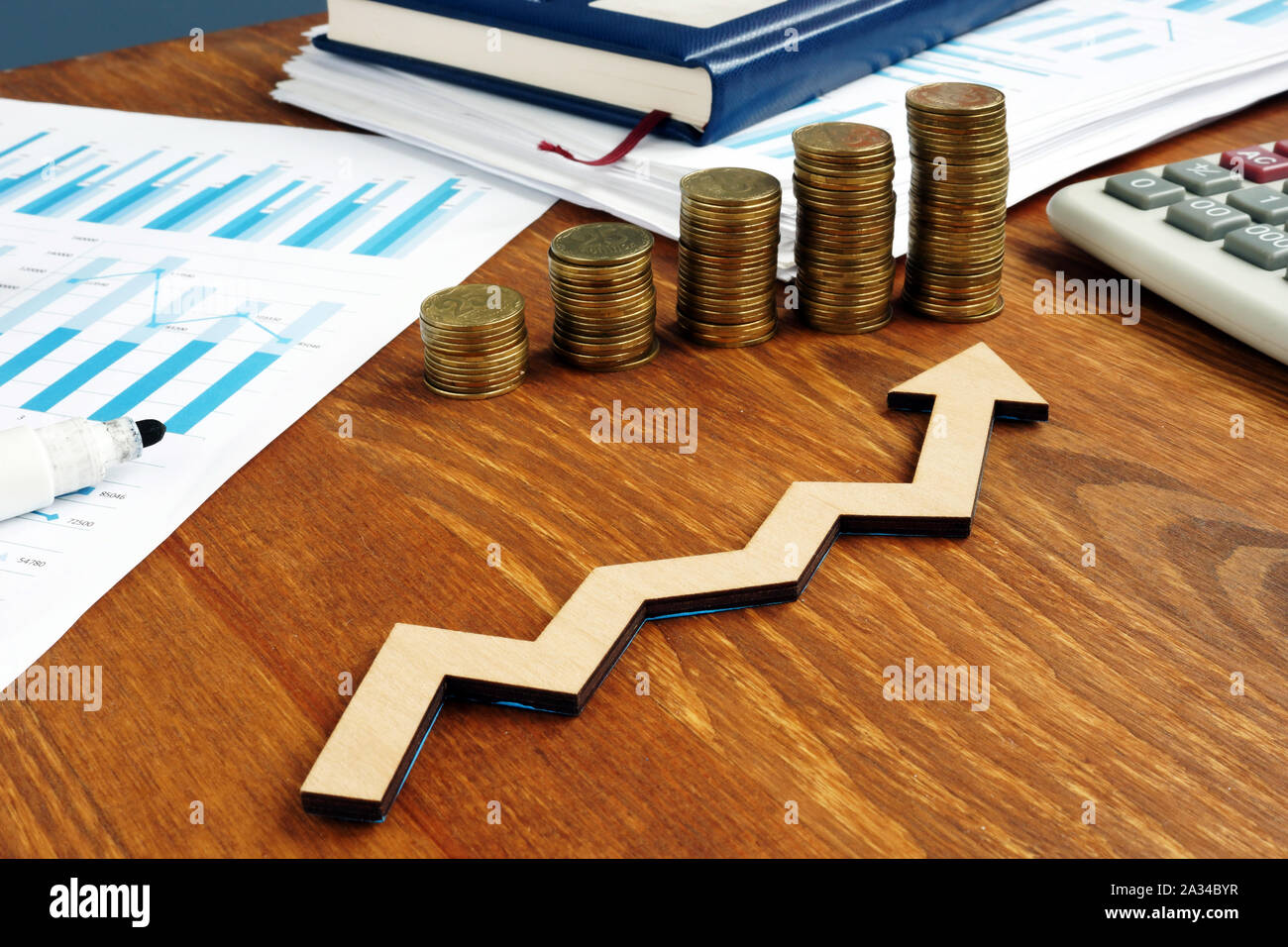 Increasing arrow and stack of money as financial saving rising concept. Stock Photo