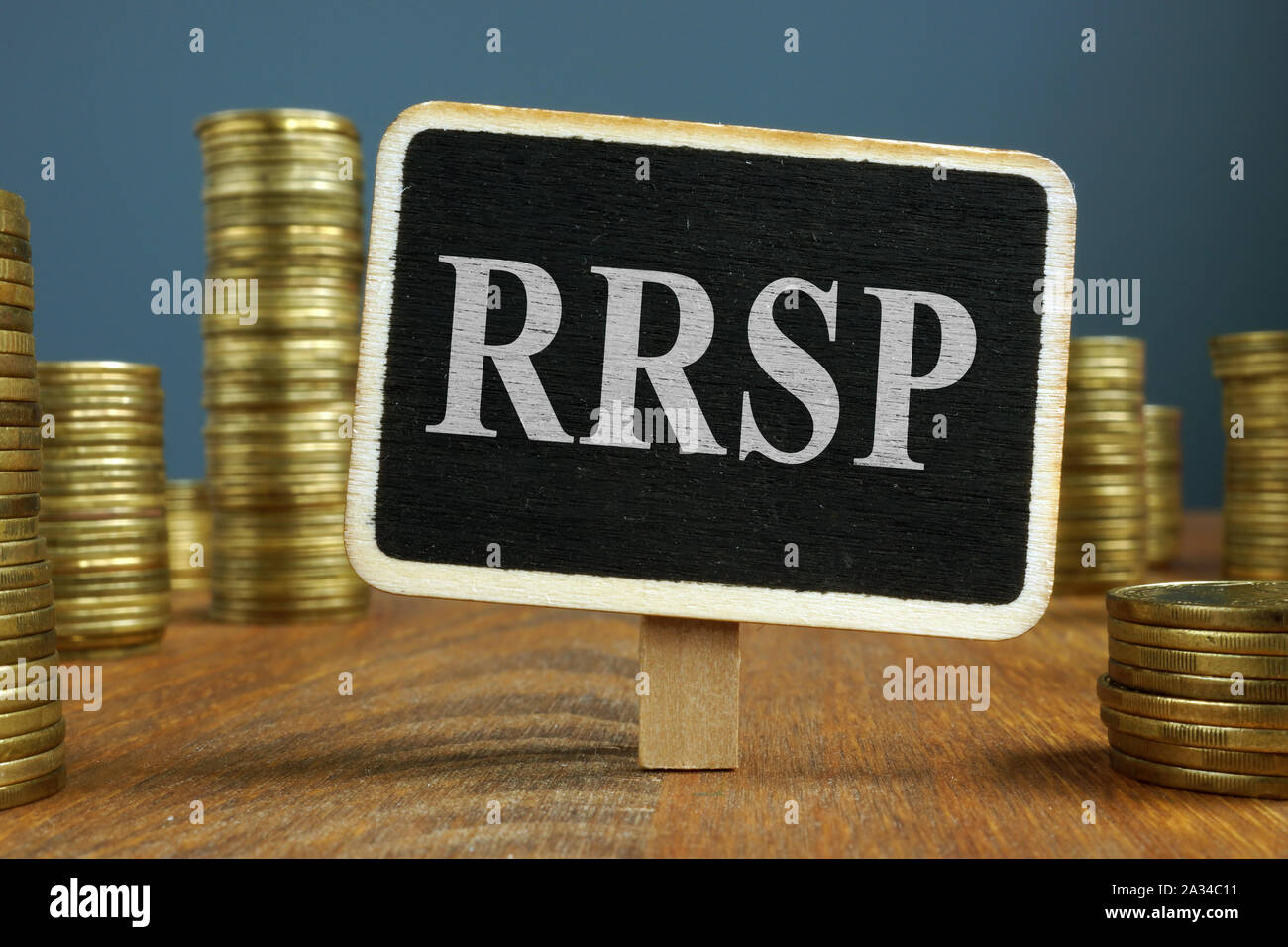 RRSP Registered Retirement Saving Plan and stacks of coins. Stock Photo