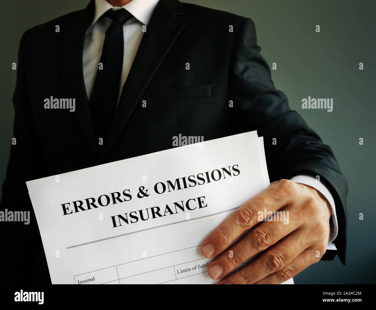 Errors and omissions E&O insurance or professional liability policy in the hands. Stock Photo