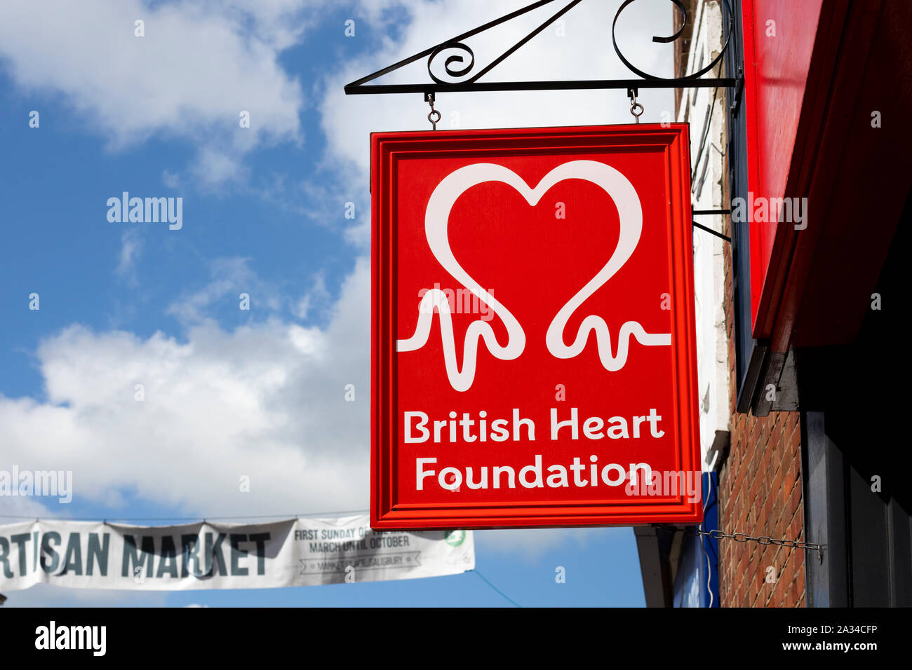 British Heart Foundation sign over charity shop, UK charity campaigns aimed to prevent heart diseases Stock Photo