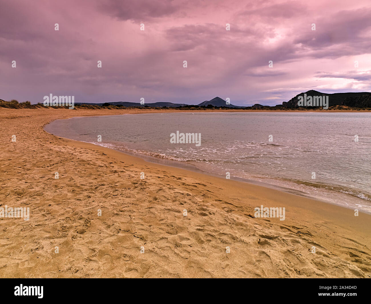 Sandy beach and dramatic cloudy sky at sunset time, Voidokoilia, Peloponnese Greece. Stock Photo