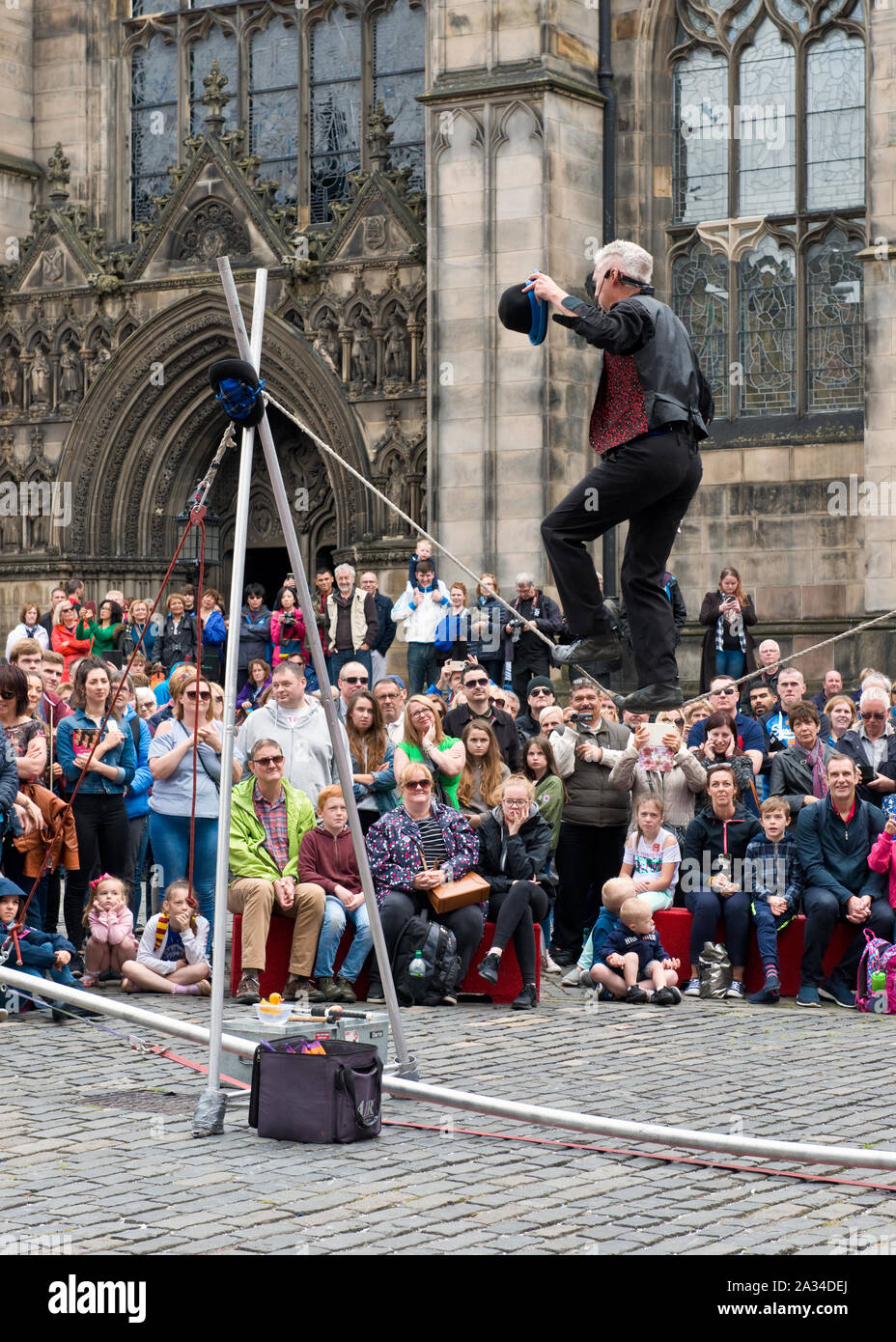 Tightrope street performer during the Edinburgh Fringe Festival. Stock Photo