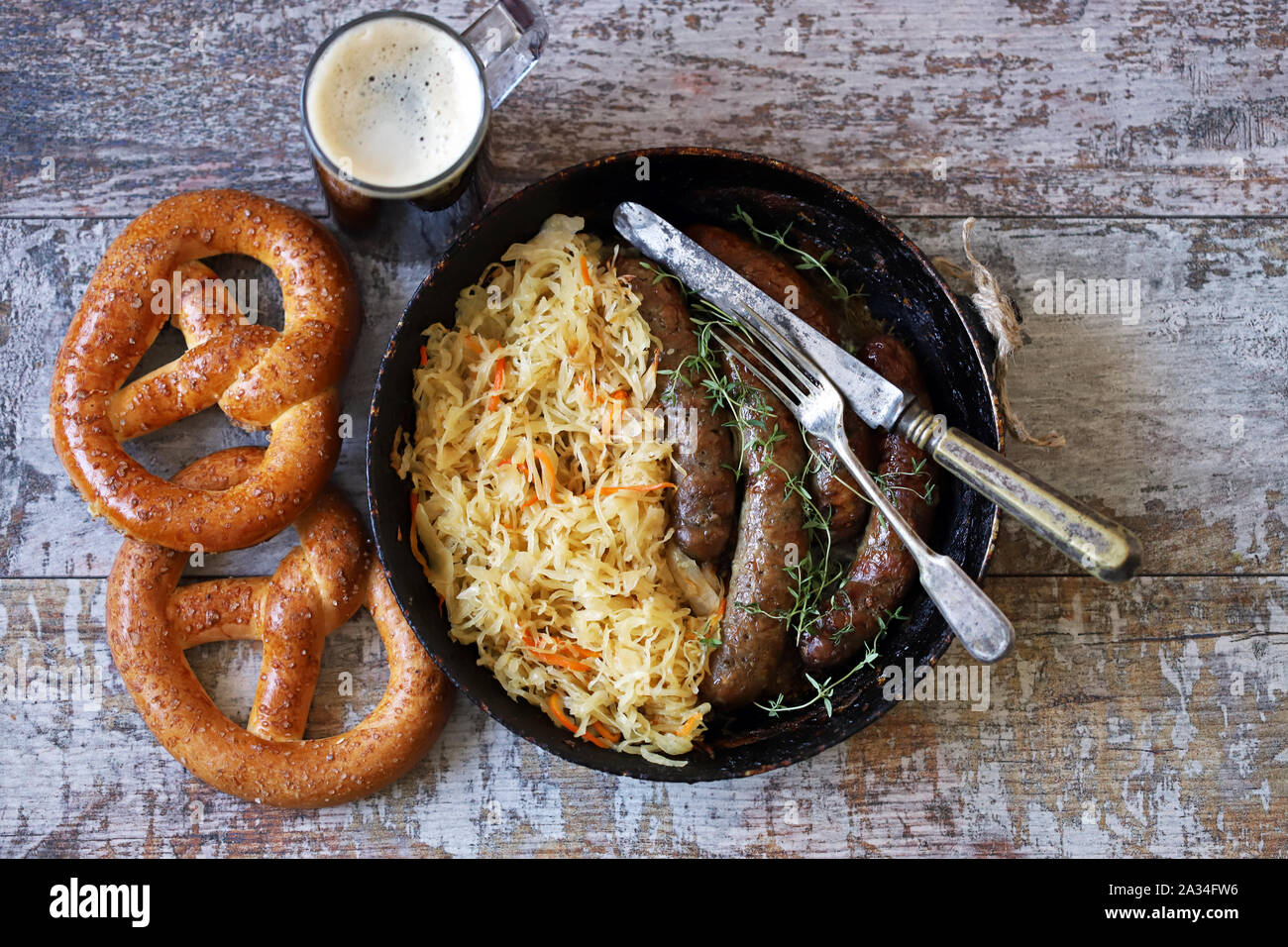 Oktoberfest food. Hot Bavarian sausages with sauerkraut in a pan. Delicious beer festival food