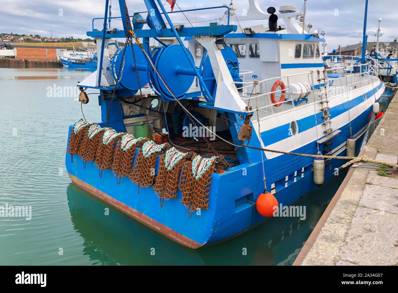 Rusty boat and nets for catching scallops Stock Photo