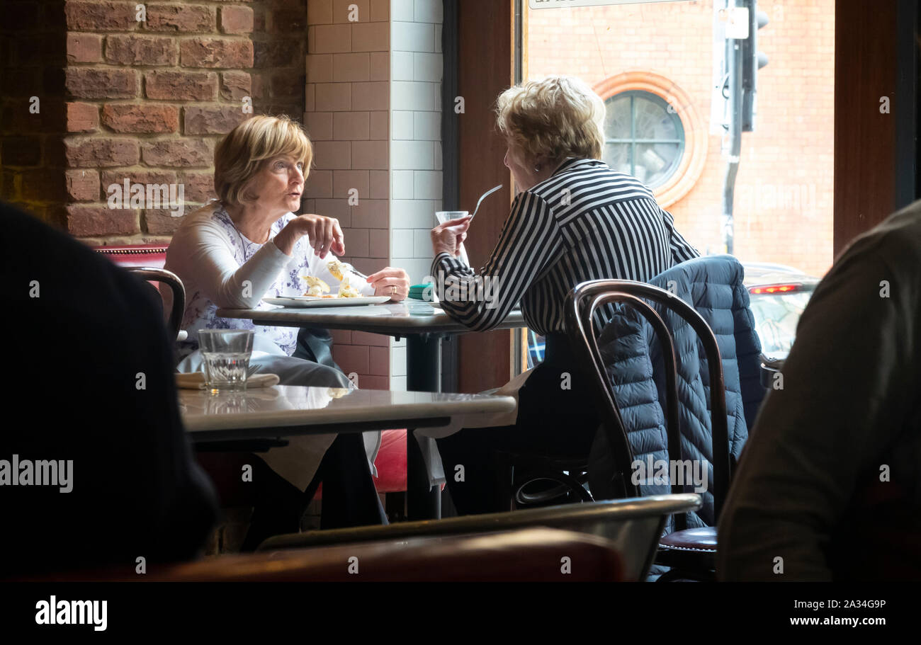 Two senior women having lunch at a bistro in Liverpool Stock Photo