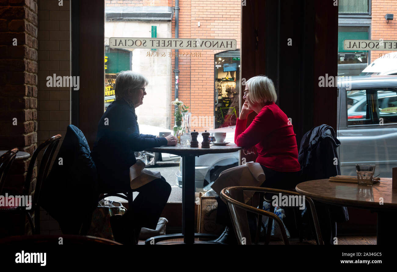 Two senior women having lunch at a bistro in Liverpool Stock Photo
