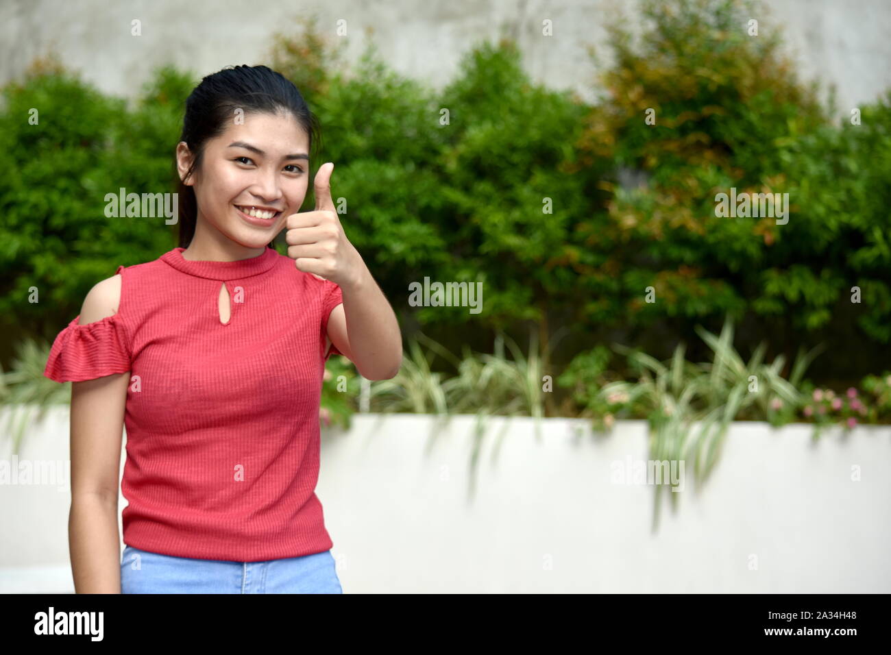 Youthful Diverse Girl With Thumbs Up Stock Photo - Alamy
