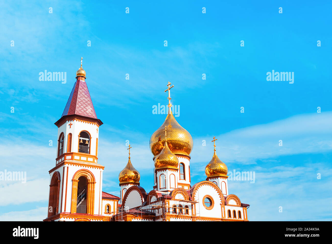Orthodox Church Golden domes with a cross on a background of blue sky ...