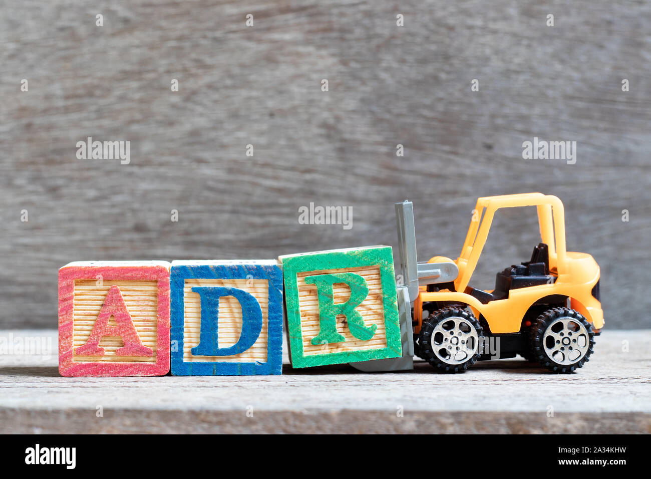 Toy Forklift Hold Letter Block R To Complete Word ADR Abbreviation Of Adverse Drug Reaction On 