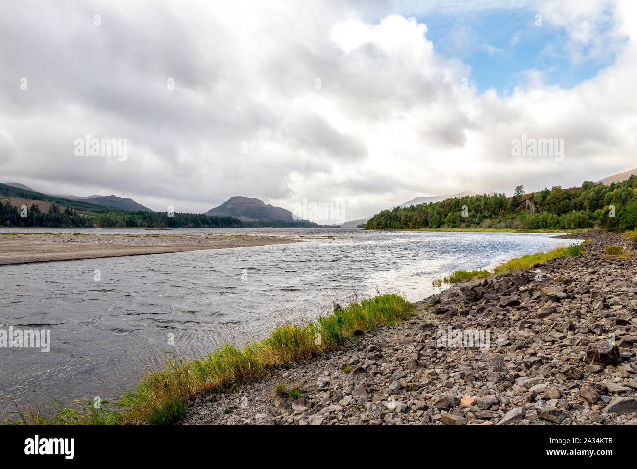 A view of River Pattack flowing to the head of Loch Laggan and Scottish highlands on the background, Cairngorms National park, Scotland, Scotland Stock Photo