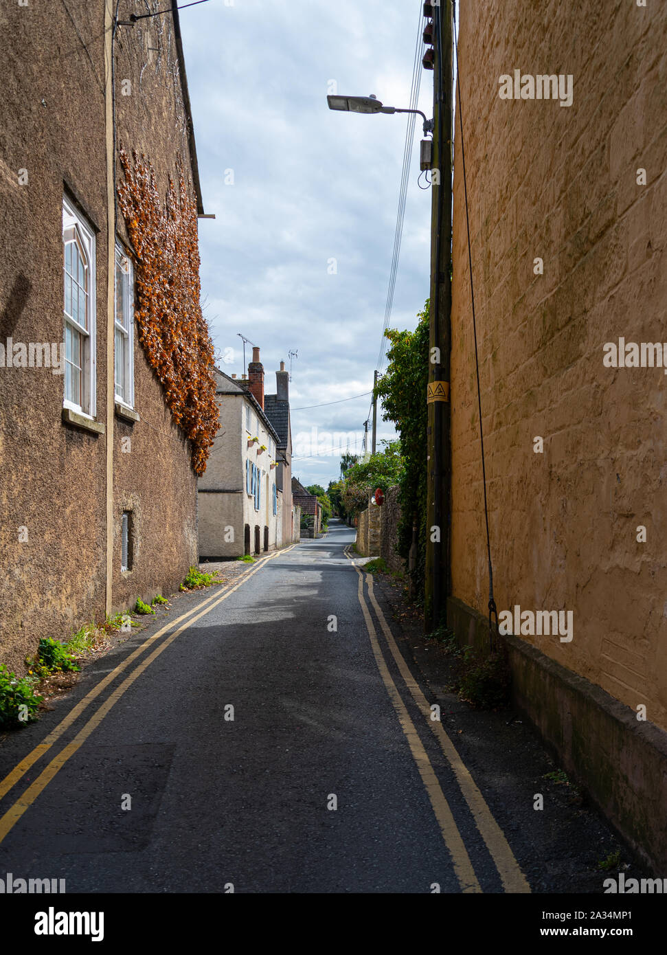 A small country lane running between houses Stock Photo Alamy