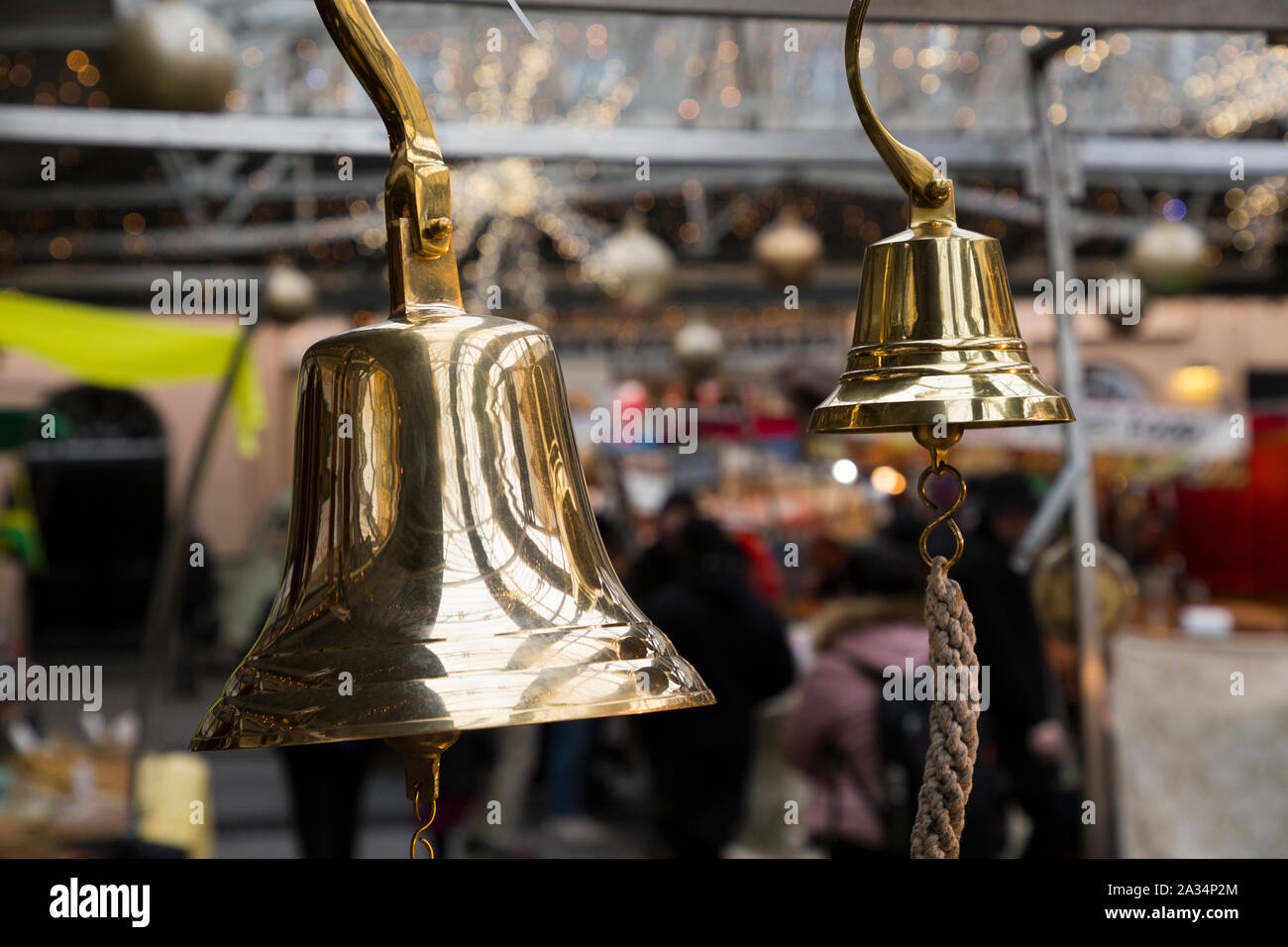 Brass bell, similar to a ships nautical bell, hanging for sale at Greenwich Market, at Christmas. Greenwich, London. UK (105) Stock Photo