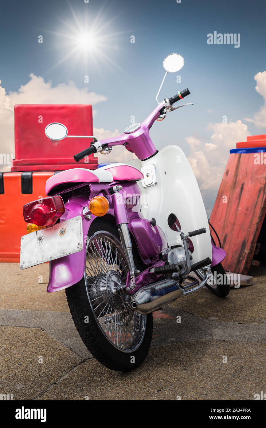 Purple old generation motorcycle with blue sky under the sun. Stock Photo