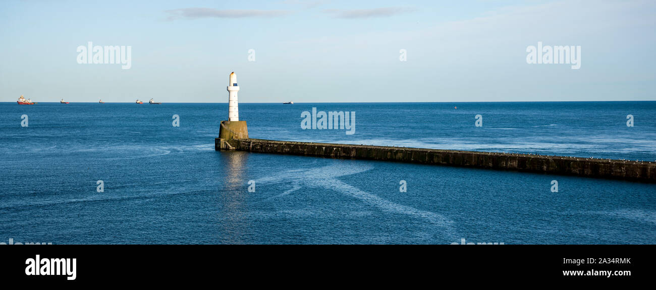 South breakwater lighthouse at the entrance to Aberdeen harbor, Scotland, United Kingdom Stock Photo
