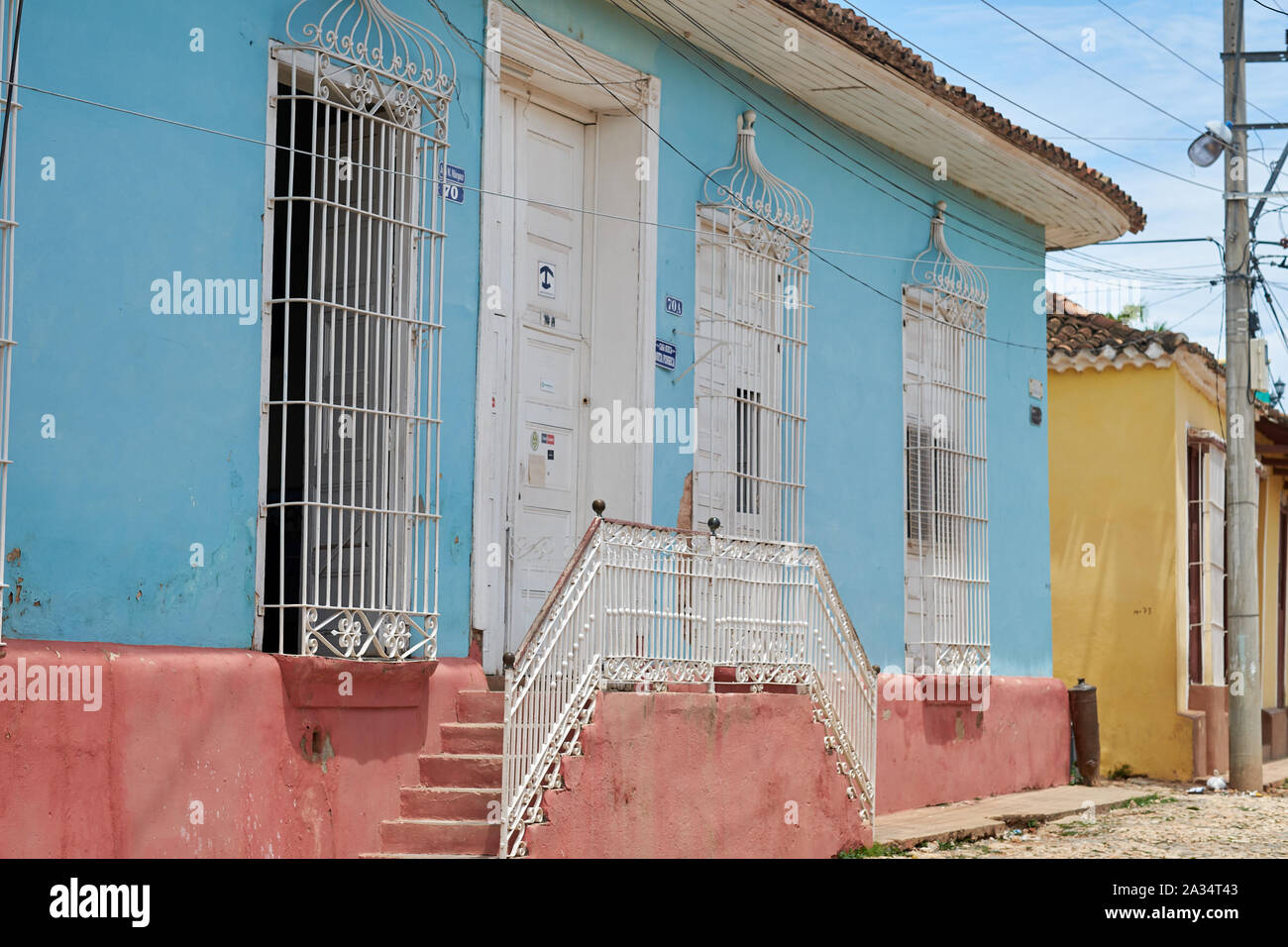 Colorful walls, sunshine and shadow on the streets of Trinidad, Cuba Stock Photo