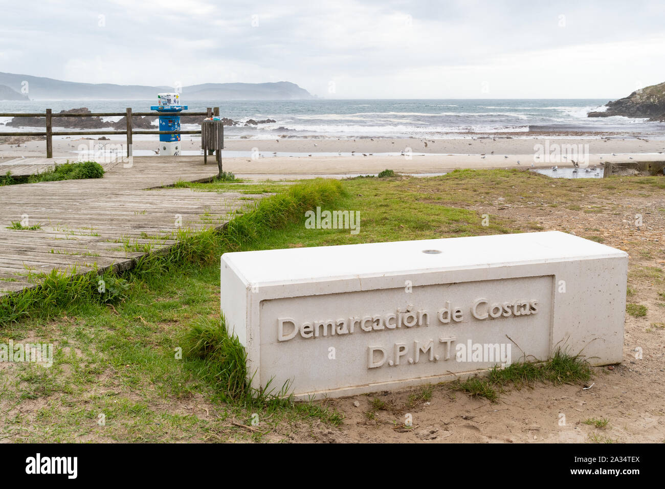 Nemina Beach, Galicia, Spain - parking and camping restrictions enforced by concrete block marked Demarcacion de Costas under Spanish coastal law 1988 Stock Photo