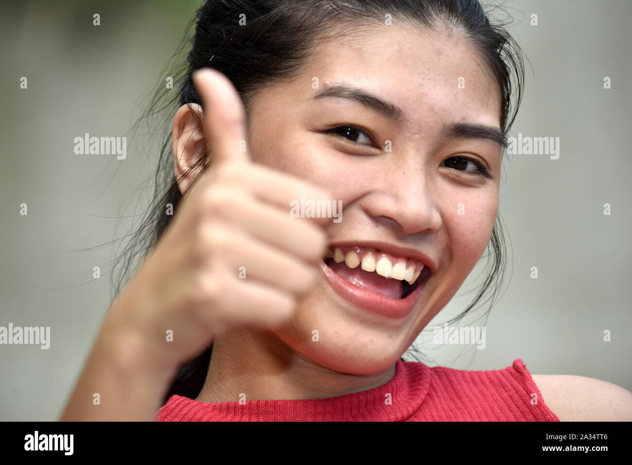 Youthful Minority Girl With Thumbs Up Stock Photo
