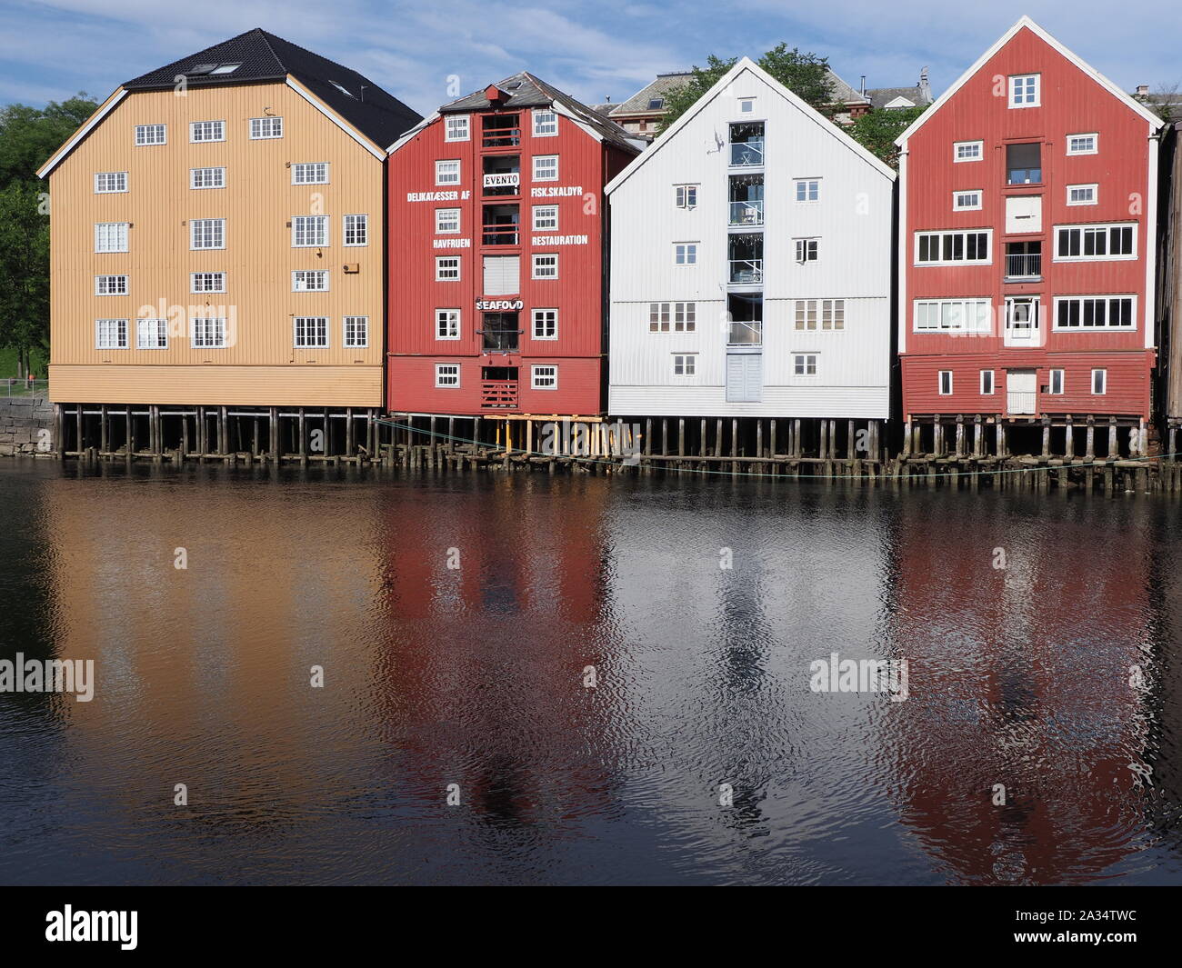 Facades of houses reflect in Nidelva river in european Trondheim city