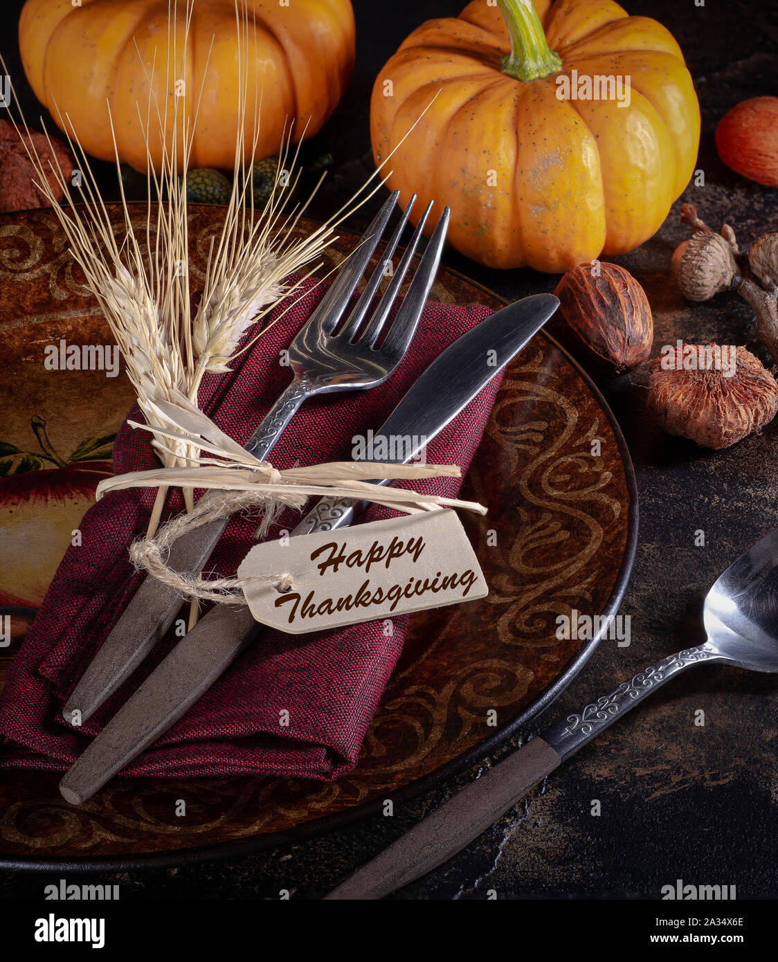 Autumn place setting and mini pumpkins on a rustic wooden table Stock Photo