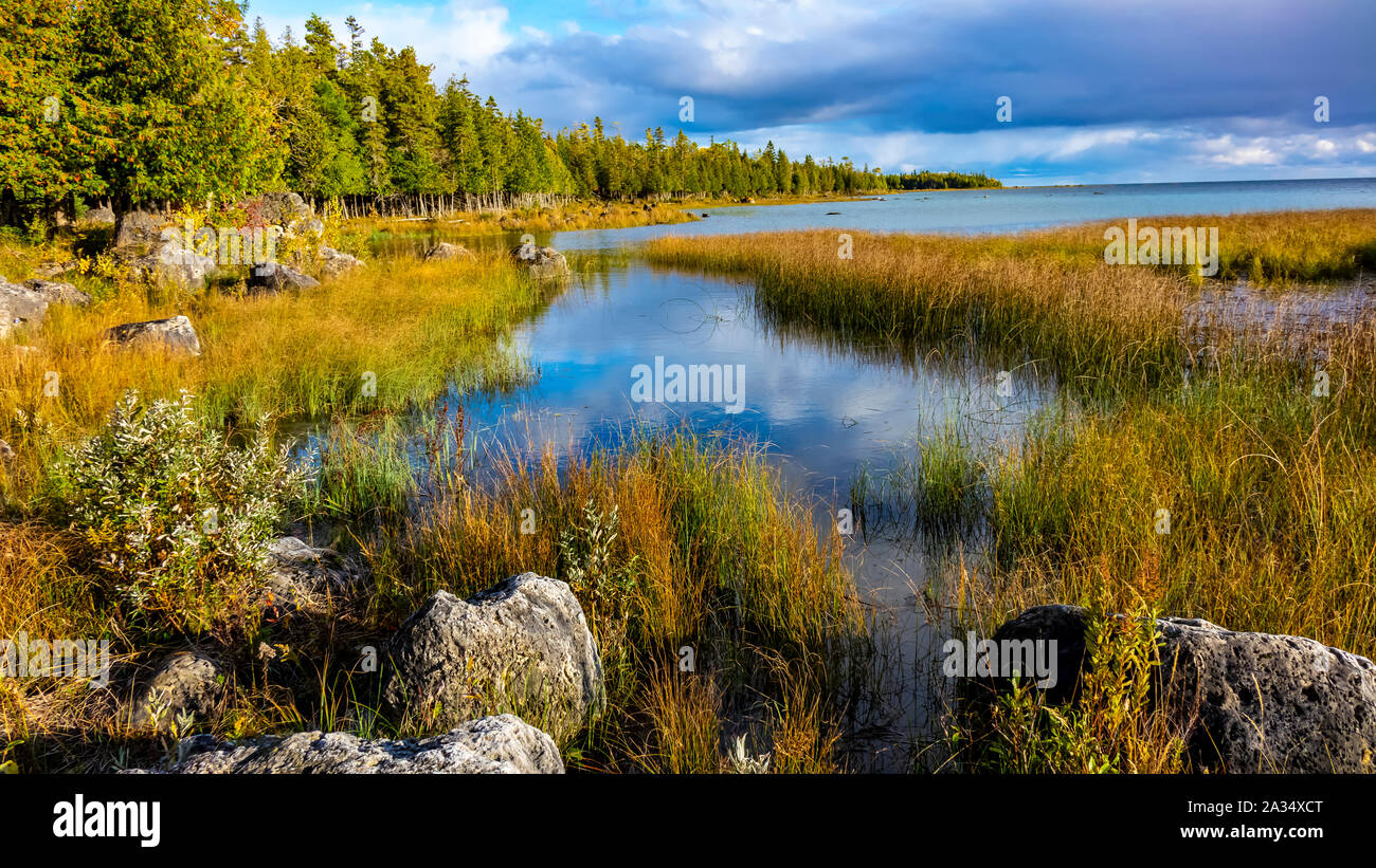 Shoreline scenic in autumn with dramatic skies around a Great Lakes bay in northern Lake Huron, Michigan, USA. Stock Photo