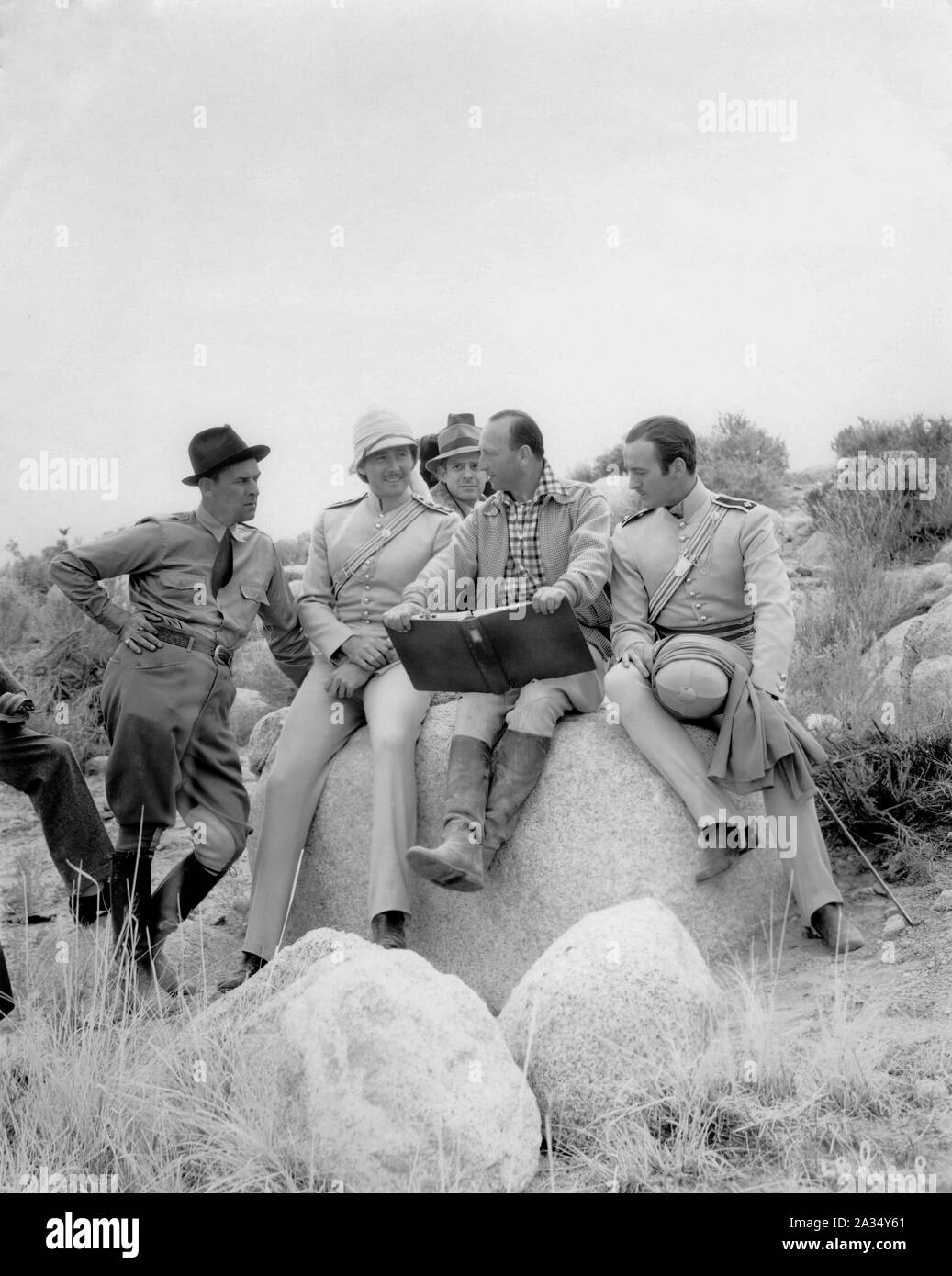 Assistant Director JACK SULLIVAN ERROL FLYNN as Major Geoffrey Vickers director MICHAEL CURTIZ and DAVID NIVEN as Captain Randall on set location candid filming THE CHARGE OF THE LIGHT BRIGADE 1936 director MICHAEL CURTIZ poem Alfred Lord Tennyson music Max Steiner Warner Bros. Stock Photo