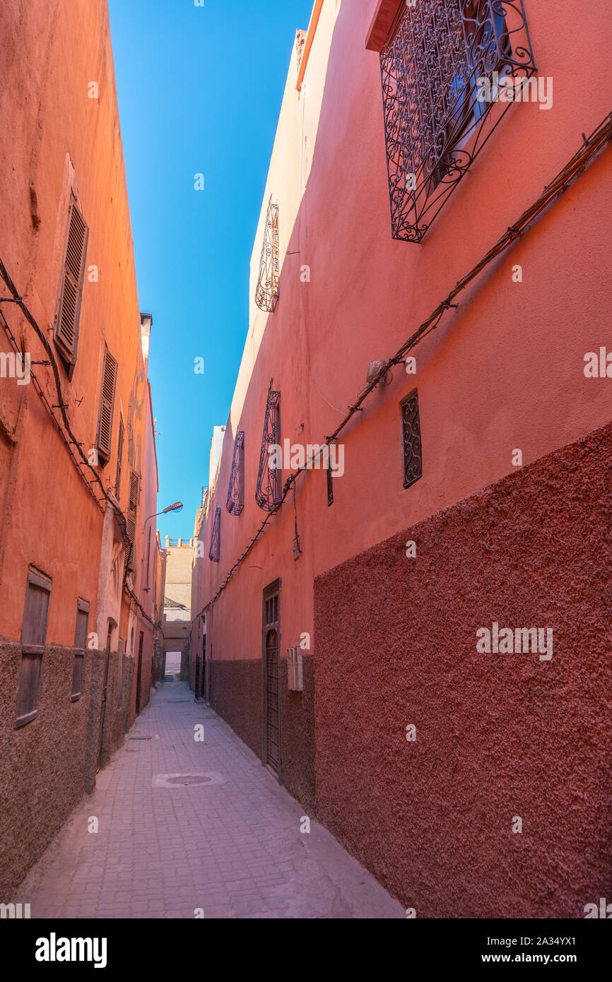 Small street in Marrakech's medina old town. In Marrakech the houses are traditionally pink. Morocco Stock Photo