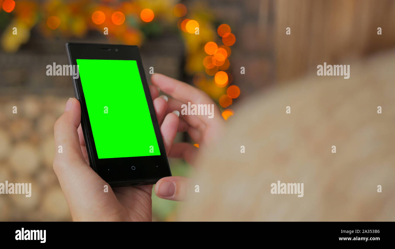Woman using smartphone with green screen Stock Photo