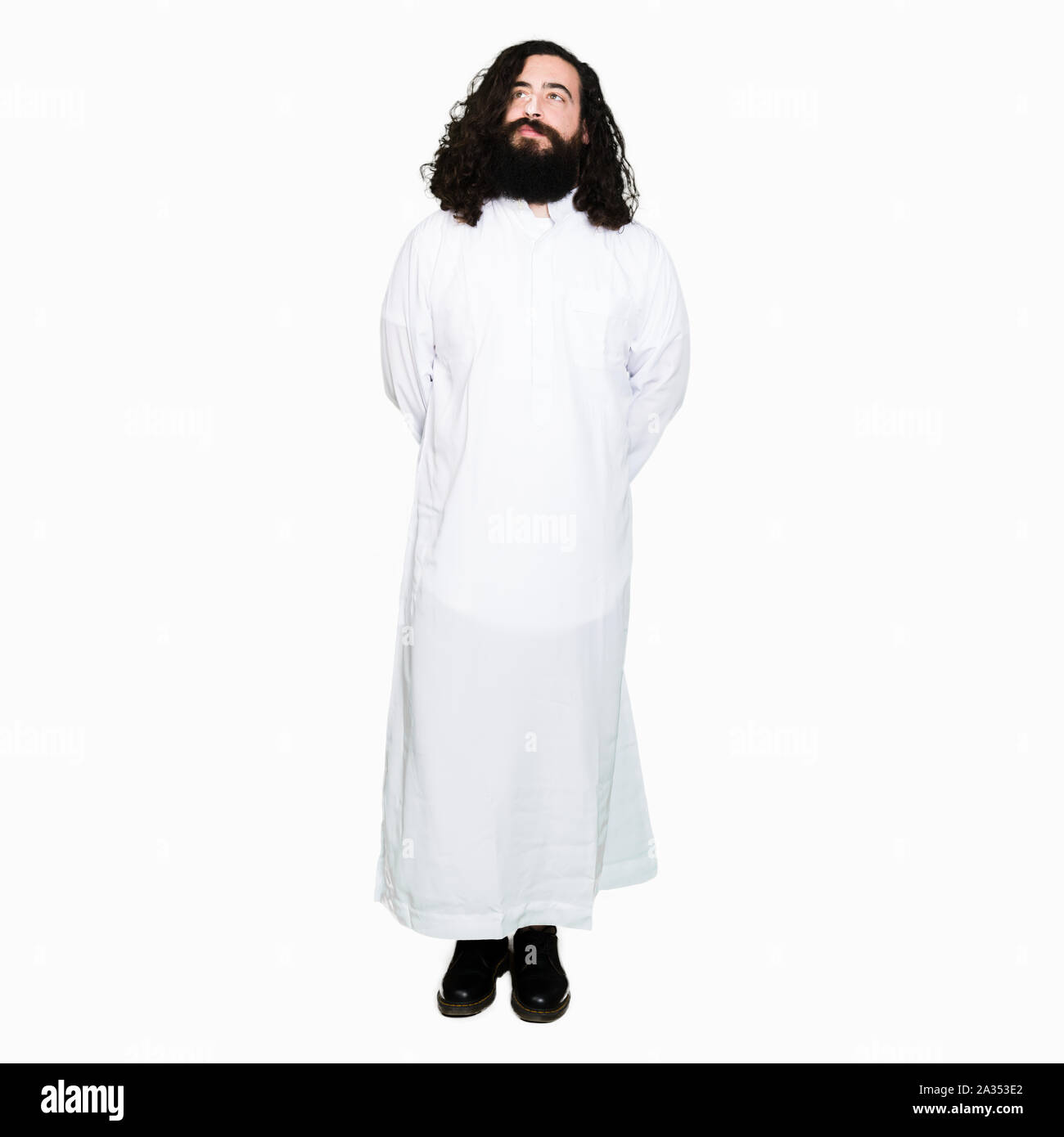 Man wearing Jesus Christ costume looking away to side with smile on face, natural expression. Laughing confident. Stock Photo