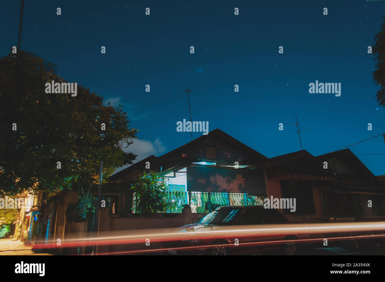 Long exposure shot of simple Bungalow concrete house in a subdivision in an Urban area in the Philippines. Stock Photo