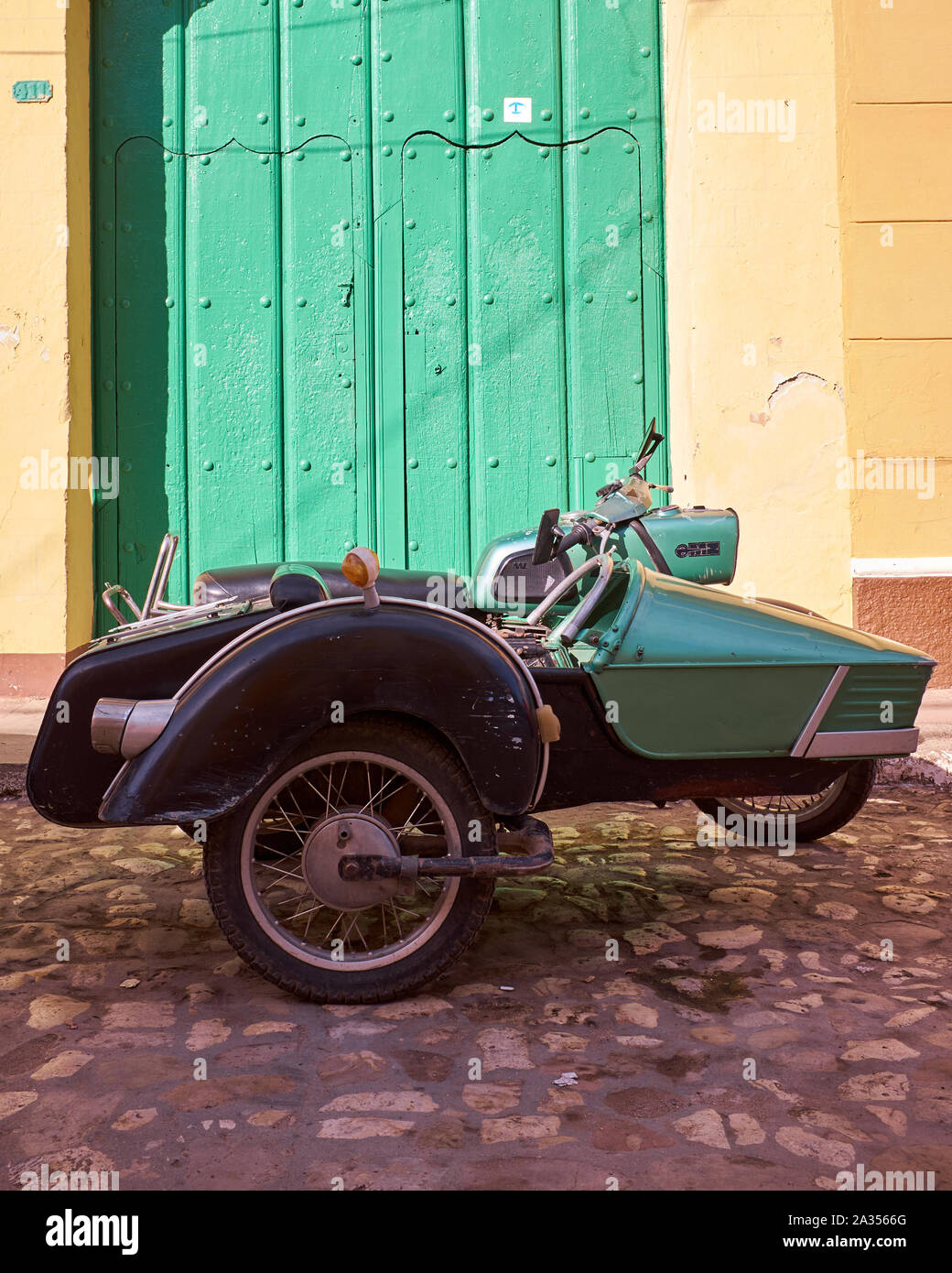 Classic motorcycle on the cobblestone streets of Trinidad, Cuba Stock