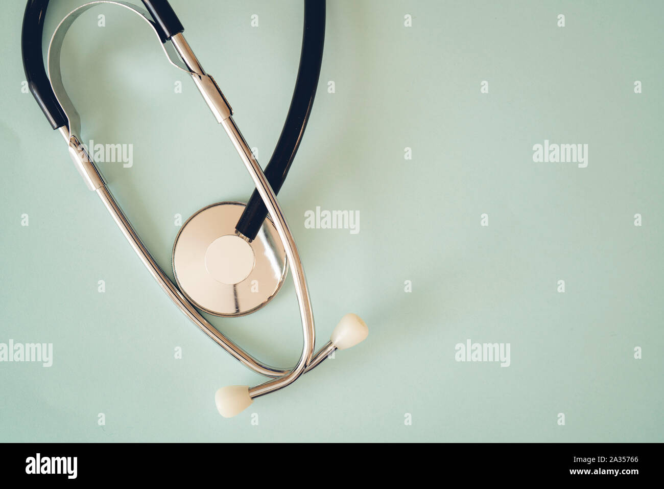 The black stethoscope on a turquoise background Stock Photo
