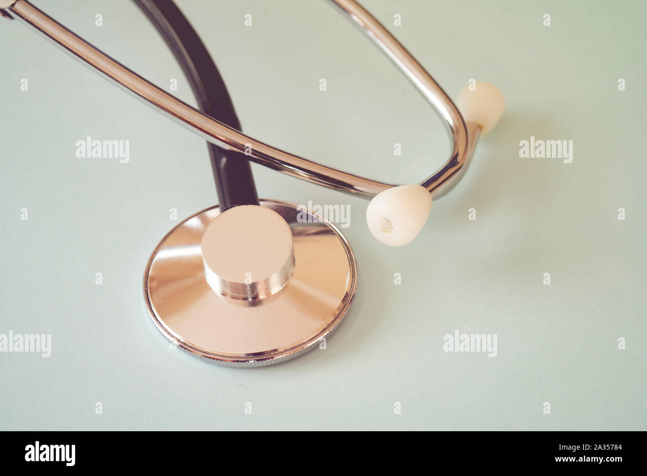 The black stethoscope on a turquoise background Stock Photo