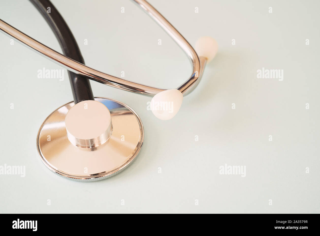 The black stethoscope on a turquoise background Stock Photo
