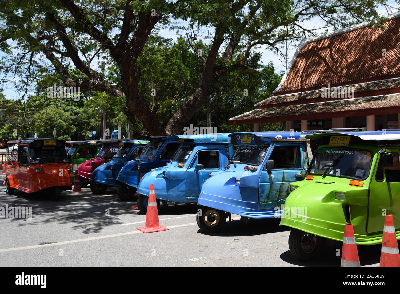 Brightly-coloured tuk-tuks parked in Rama Public Park, Ayutthaya, Thailand Stock Photo