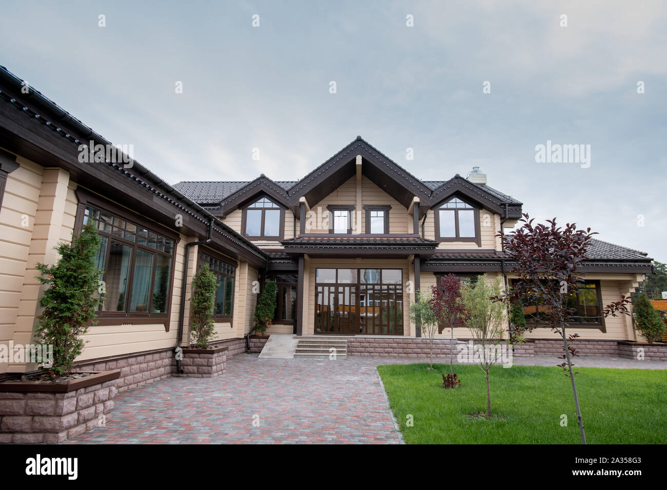 Exterior of modern comfortable cottage or house with front yard Stock Photo