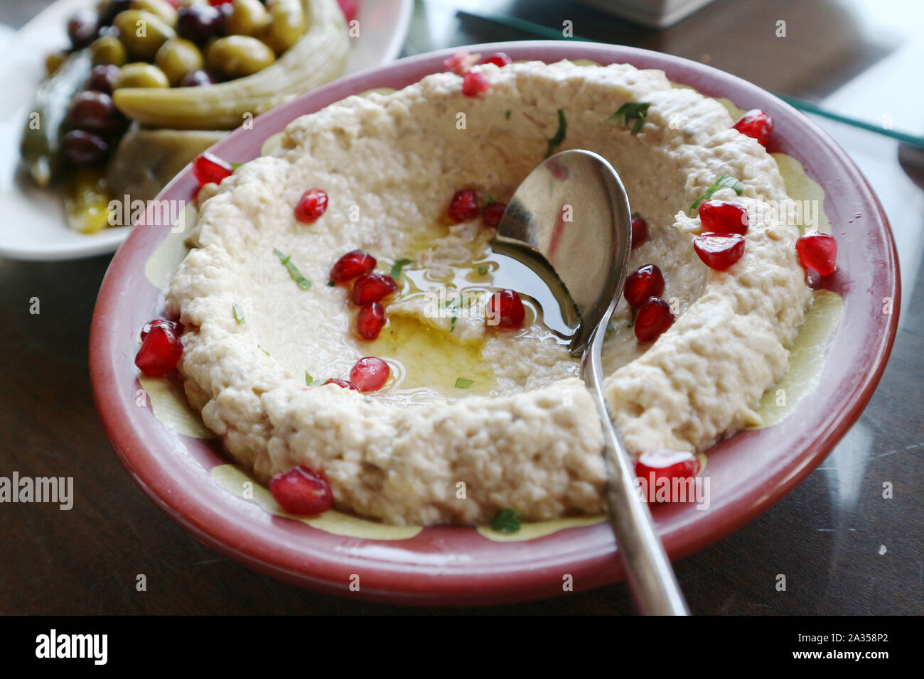 Typical Middle Eastern ground eggplant dip known as mutabbal or baba ghanouj with pomegranate seeds Stock Photo
