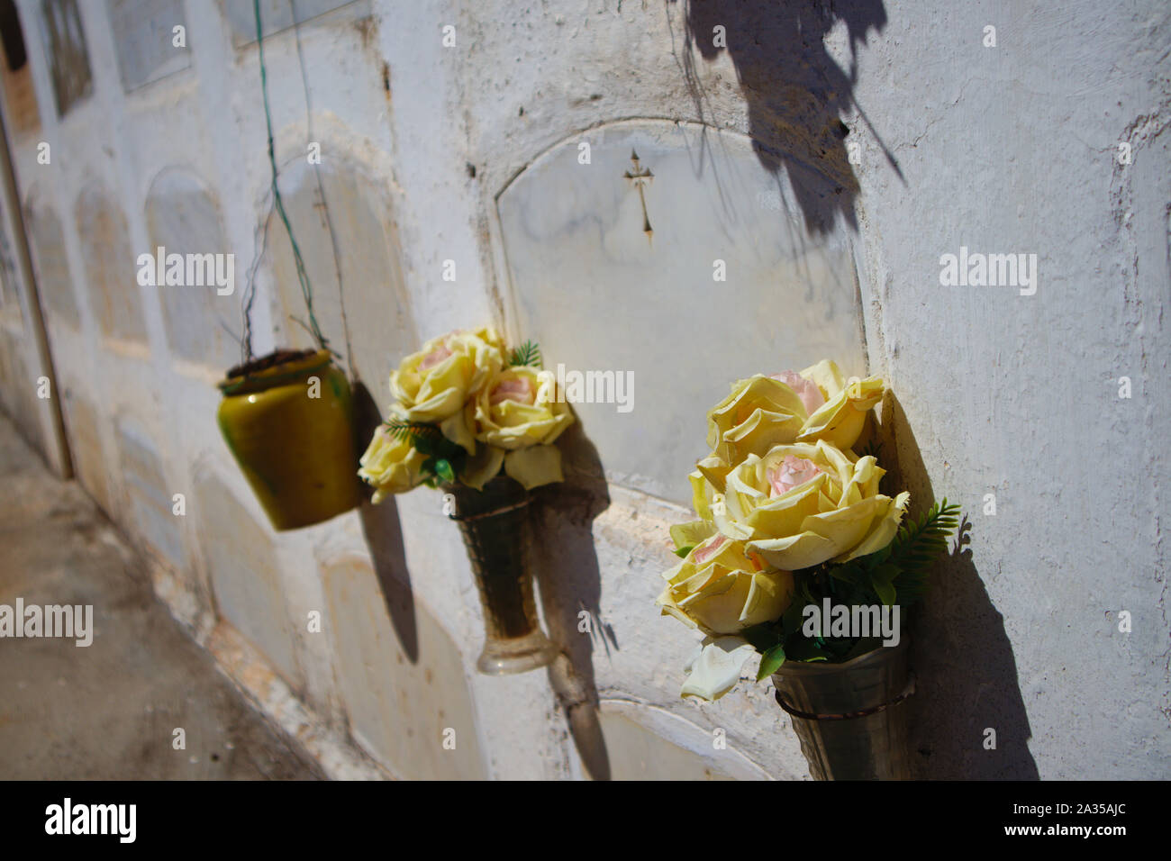 A floral offering in the form of yellow cloth flowers in one of the ...