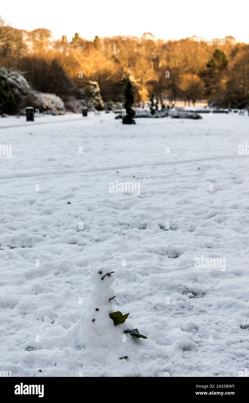 A small snowman built on a central alley in Seaton Park, Aberdeen, Scotlan Stock Photo