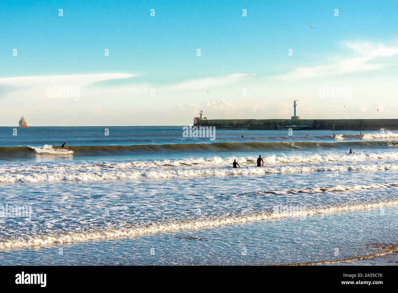 Many surfers enjoy a nice sunny winter weather at Aberdeen beach, Scotland Stock Photo