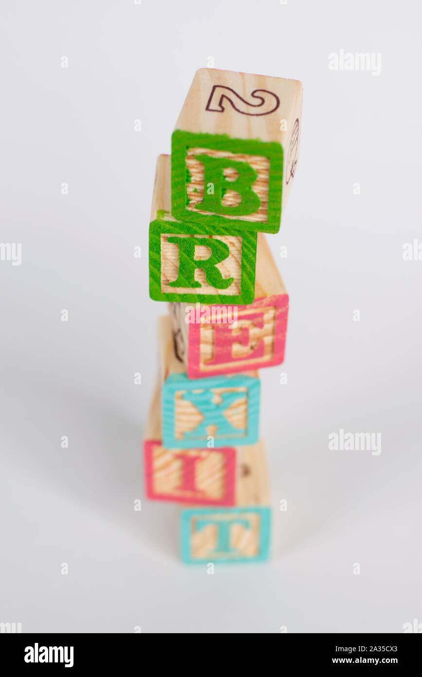 The word 'Brexit' in coloured wooden blocks. Unorganised pile which is nearly falling down. Taken in portrait mode, copy space available. Stock Photo