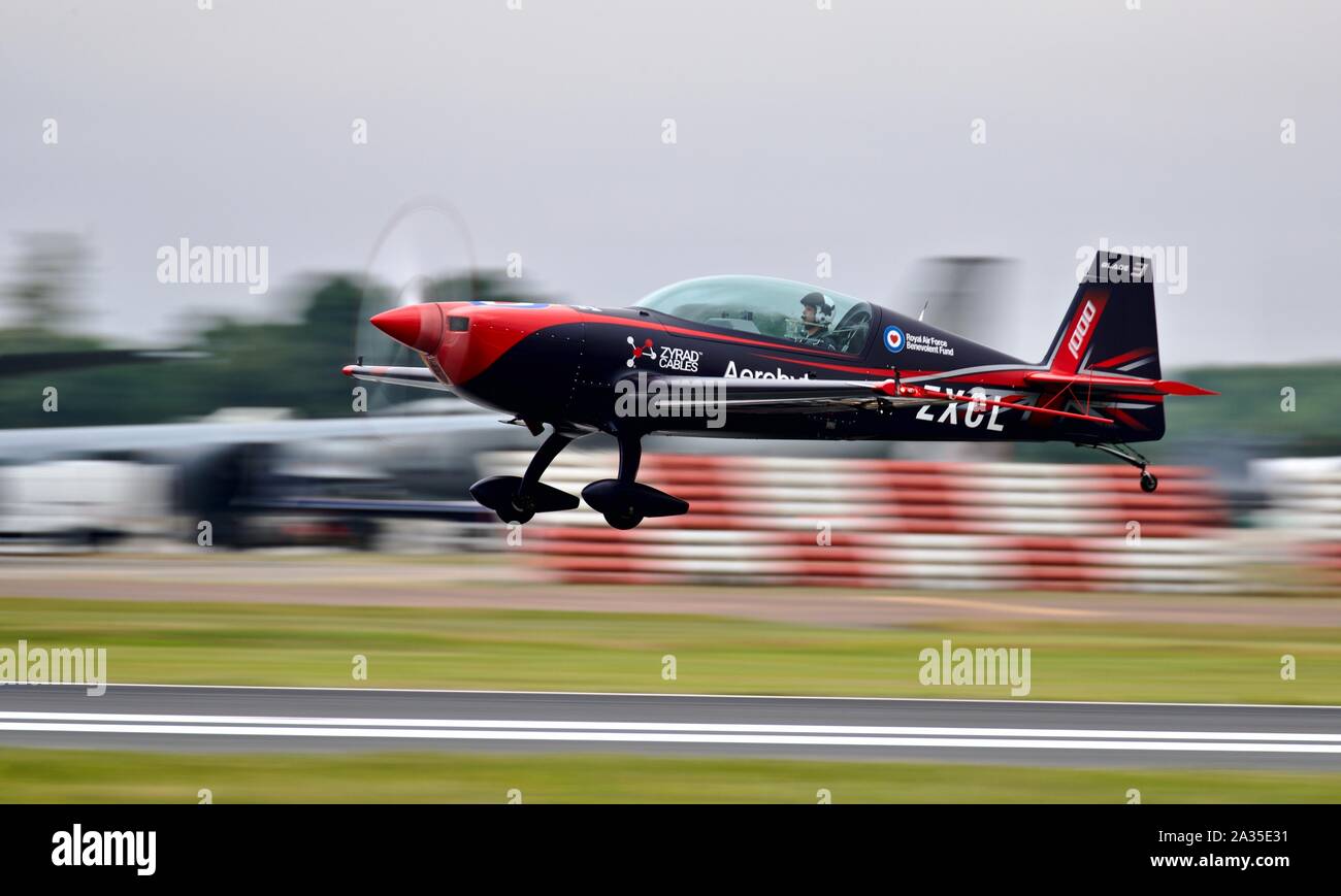 The Blades Extra EA-300 aircraft (G-ZXCL) landing at RAF Fairford after performing at the Royal International Air Tattoo 2019 Stock Photo