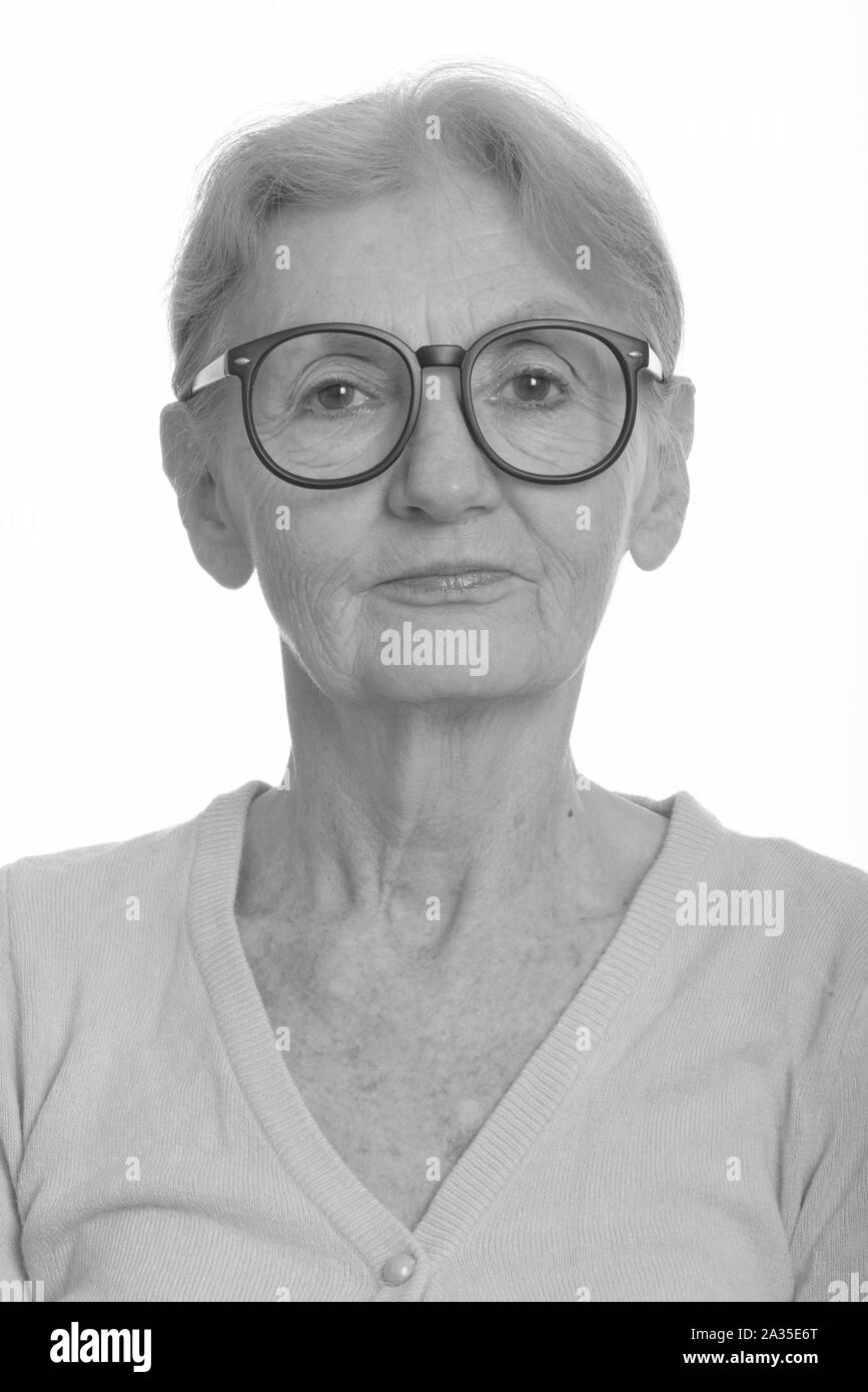 Face of senior nerd woman wearing geeky eyeglasses Stock Photo
