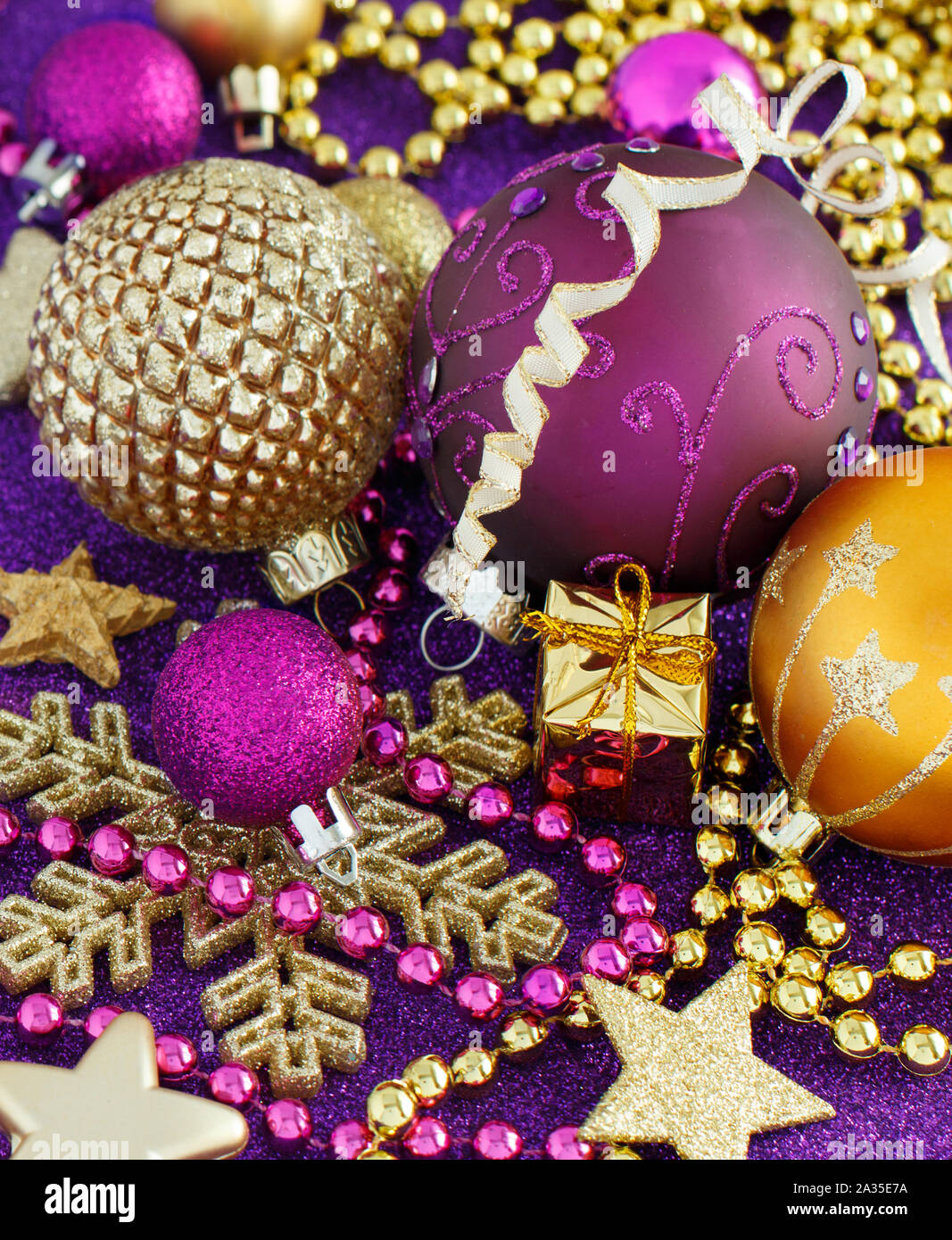 Golden and purple Christmas decorations and baubles close up Stock Photo