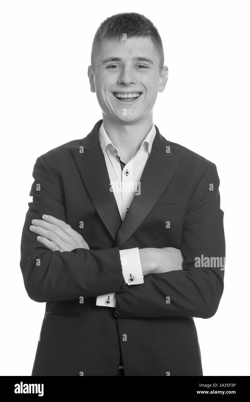 Studio shot of young happy businessman smiling with arms crossed Stock ...