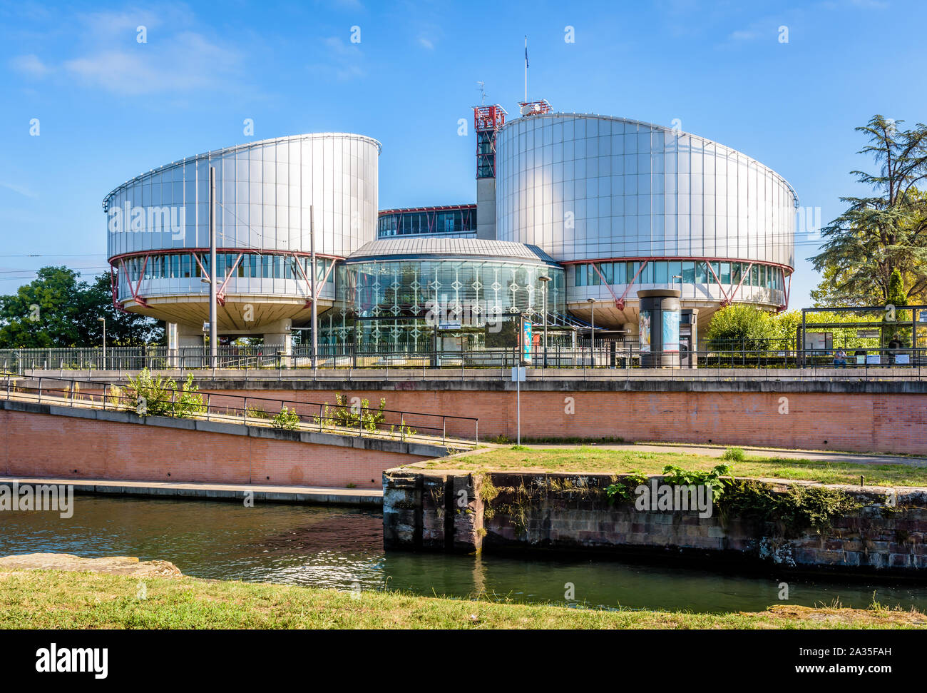 The building of the European Court of Human Rights in Strasbourg, France was designed by Richard Rogers and built in 1995 by the Marne-Rhine canal. Stock Photo