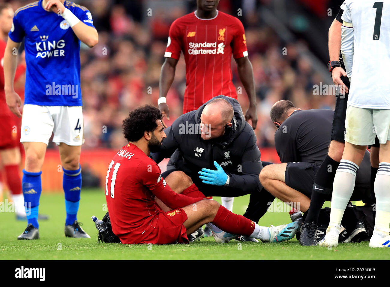 Liverpool's Mohamed Salah sits injured on the pitch after a battle for the ball with Leicester City's Hamza Choudhury (not pictured) during the Premier League match at Anfield, Liverpool. Stock Photo