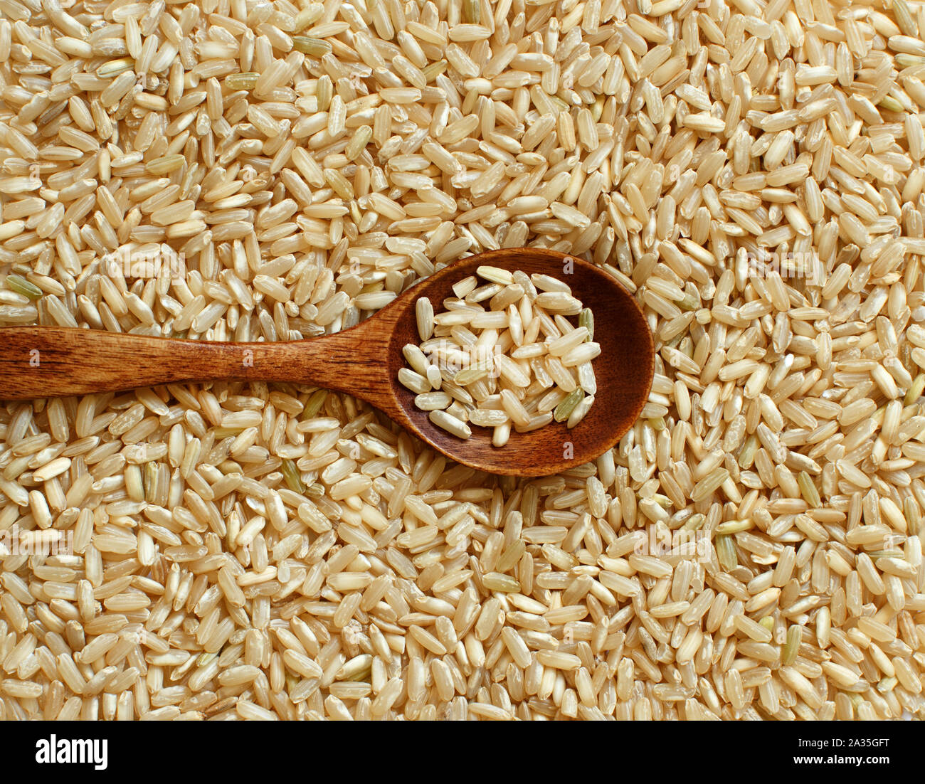 Pile of Brown rice with a spoon top view Stock Photo - Alamy