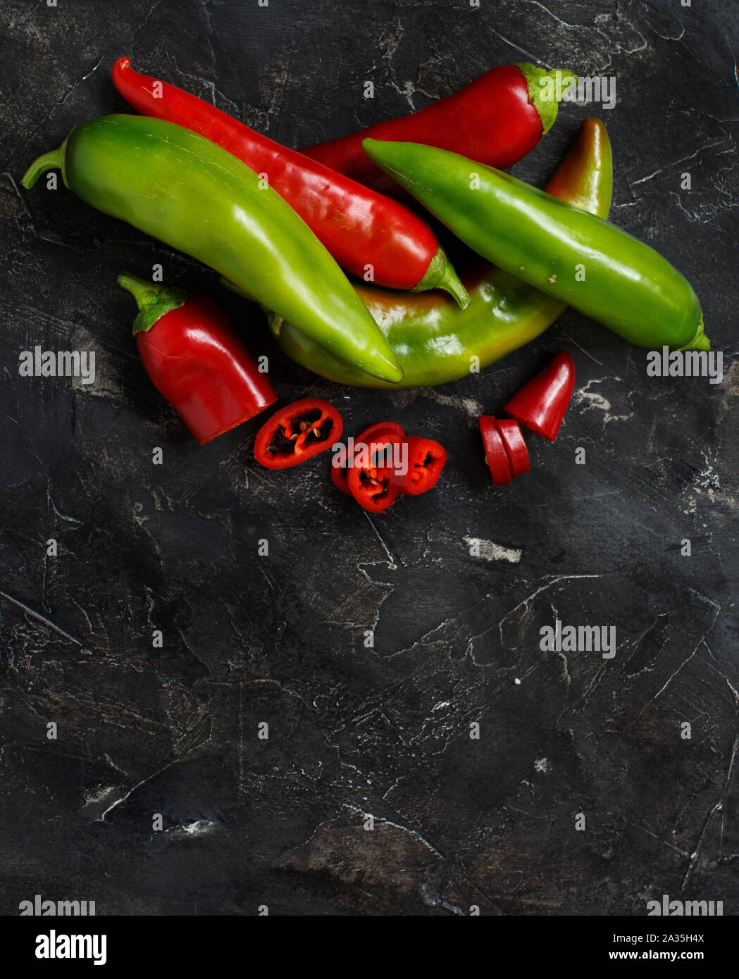 Red and green sweet peppers on dark background Stock Photo - Alamy