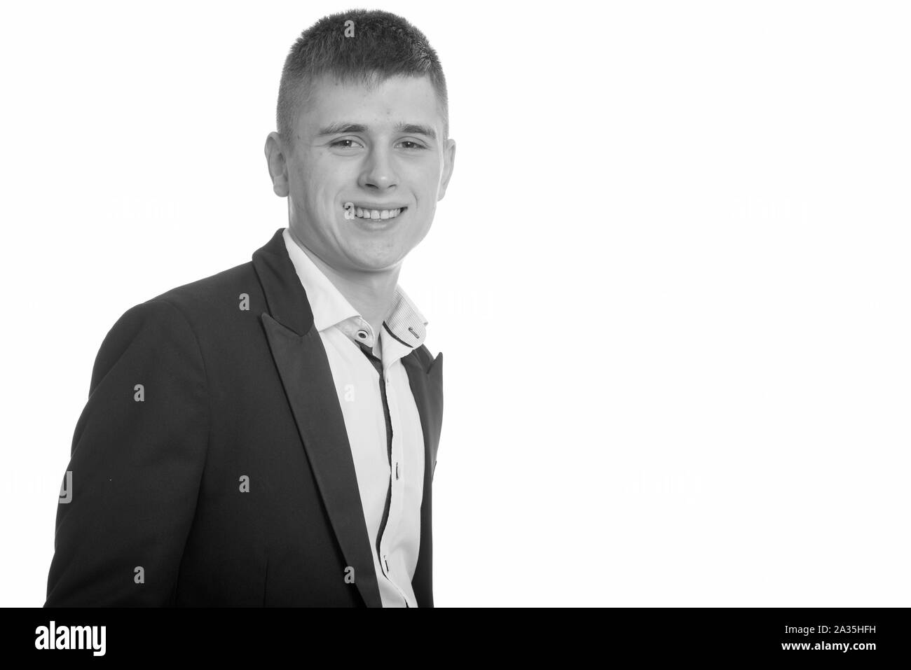 Studio shot of young happy businessman smiling Stock Photo - Alamy